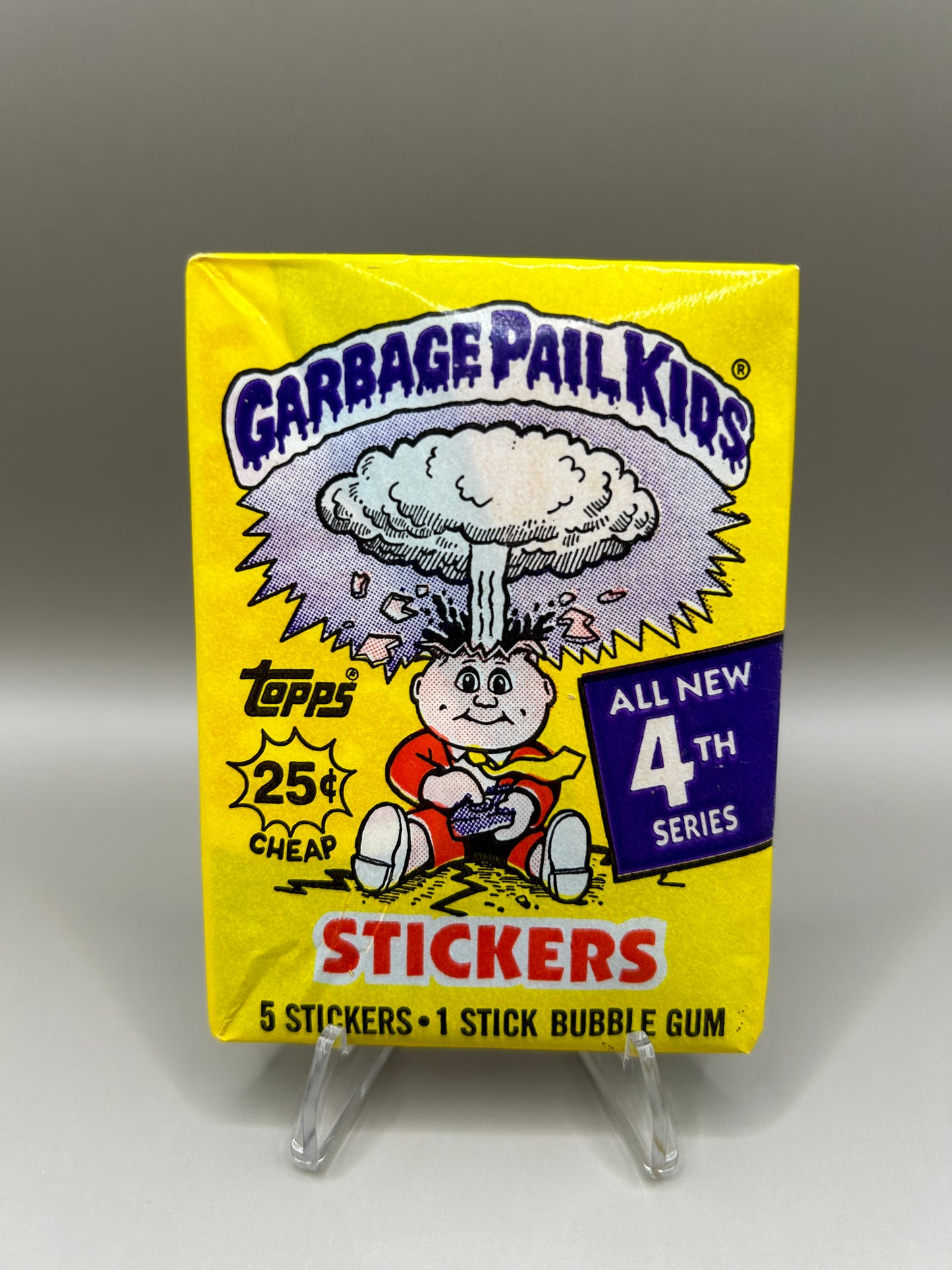 Sealed Garbage Pail Kids 4th Series wax pack featuring bright yellow packaging with iconic artwork of an exploding head character, includes 5 stickers and 1 stick of bubble gum, authentic 1986 Topps collectible