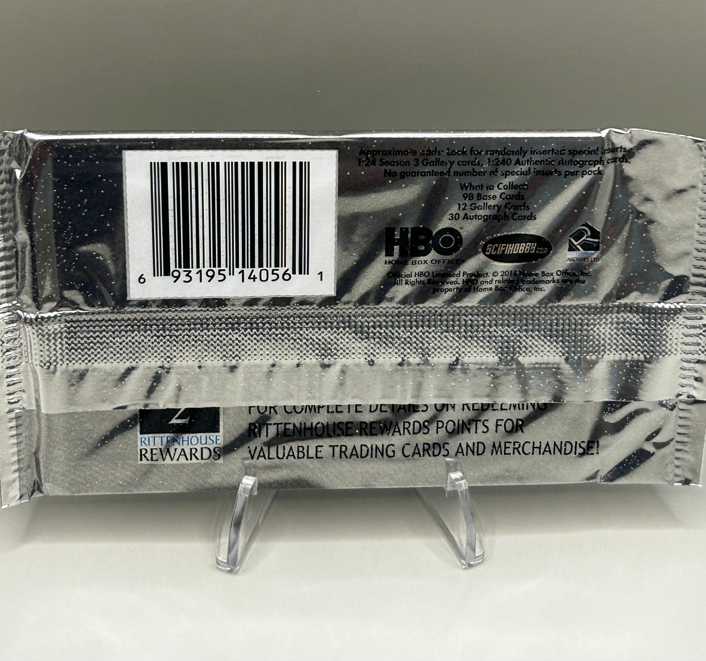 Back view of a sealed Game of Thrones Season 3 trading card pack showing barcode, licensing details, and collectible card odds