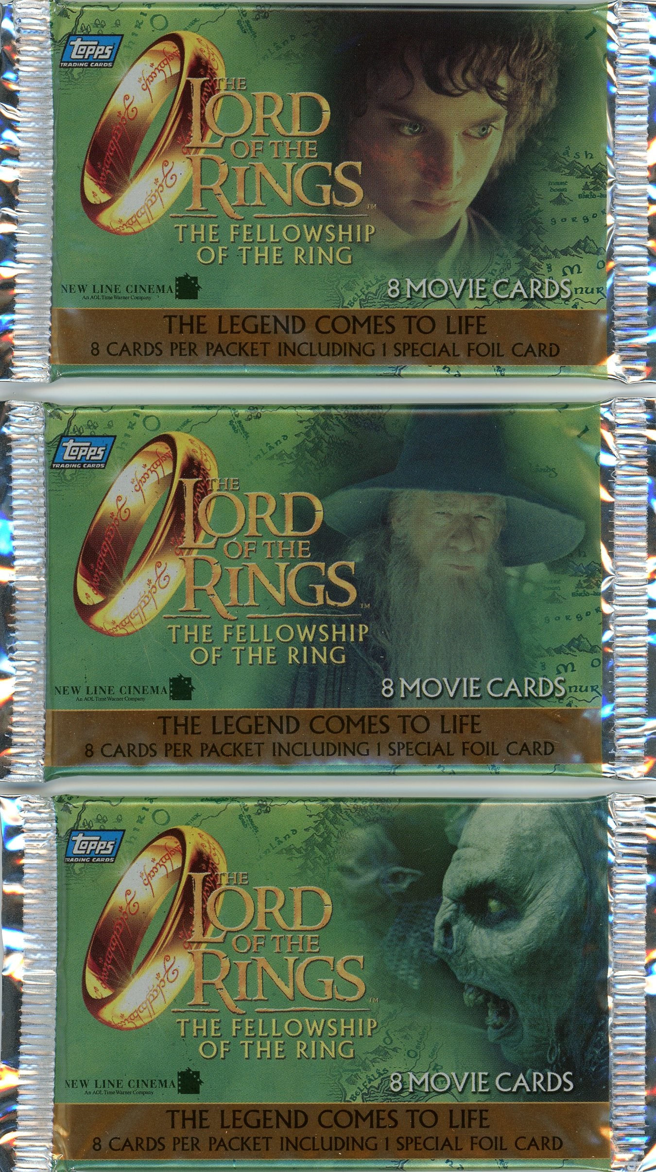Three sealed trading card packs for The Lord of the Rings: The Fellowship of the Ring by Topps. Each pack features the iconic golden ring and images of Frodo, Gandalf, and a Ringwraith. The text reads, “The legend comes to life” and “8 movie cards per packet including 1 special foil card.” The packaging has a green background with a map design.