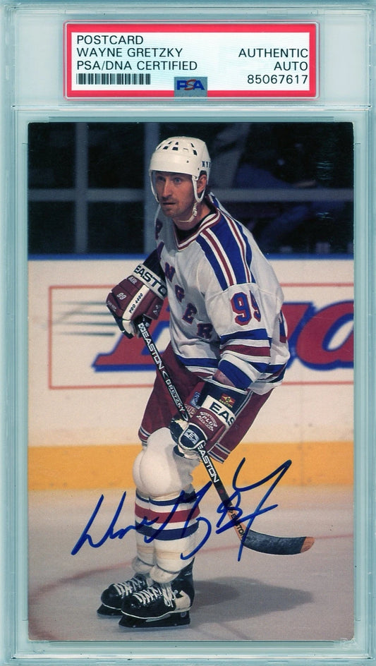 Front of PSA/DNA encapsulated Wayne Gretzky signed postcard showing him skating with the New York Rangers